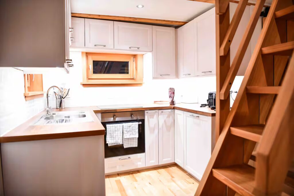 Fitted kitchen and wooden staircase at Le Raccard de Louise