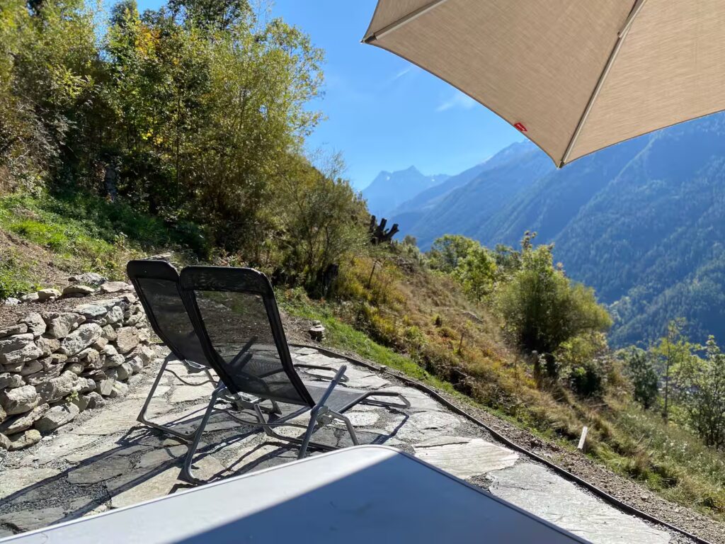 Terrace with loungers and valley view at Le Raccard de Louise